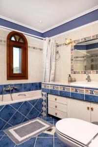 a bathroom with a toilet and a sink at VILLA MANTI in Ouranoupoli