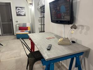 a table with a tv on top of it at Coccia resort / Norcia centro in Norcia