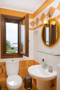 a bathroom with a toilet and a sink at VILLA MANTI in Ouranoupoli +26 photos