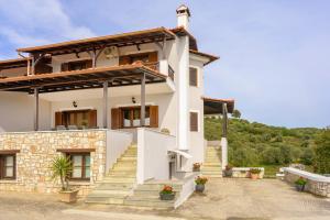 a white house with stairs in front of it at VILLA MANTI in Ouranoupoli