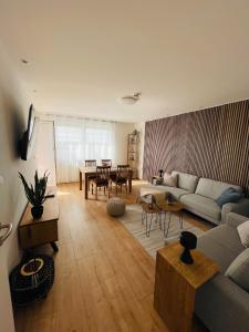 a living room with a couch and a table at Juniorsuite-Apartment Weiden in Weiden