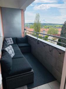a balcony with a couch and a view at Juniorsuite-Apartment Weiden in Weiden