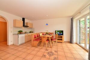 a kitchen with a table and chairs in a room at Ponyhof Schöllang in Oberstdorf