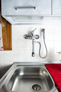 a sink in a kitchen with a faucet at Colombohouse87 in Quartu SantʼElena