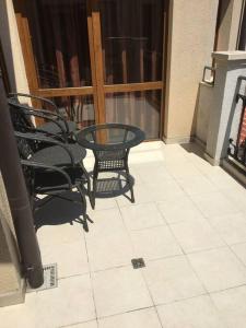 a patio with a table and chairs on a balcony at 3 Bedroom Apt with Pool Views at Arcadia Complex in Sunny Beach