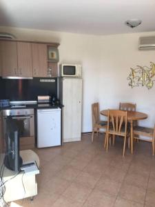 a kitchen with a table and a dining room at 3 Bedroom Apt with Pool Views at Arcadia Complex in Sunny Beach