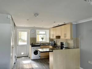 a kitchen with a sink and a dishwasher at Cottage in Par, 4mi. from Fowey in Saint Blazey