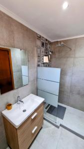 a bathroom with a sink and a shower at Anna Garden Sidari in Sidari