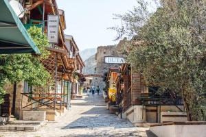 an alley in an old town with people walking down it at Old Town Bar Apartments in Stari Bar