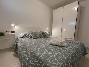 a bedroom with a large bed with two pillows at La Maison Des Arches in Porto Cervo