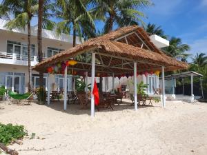 a hut on the beach in front of a resort at Lucky Spot Beach Bungalow in Song Cau