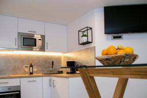 a kitchen with a counter with a bowl of oranges at Shtorya - city centre apartman in Split