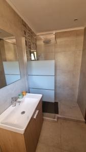 a bathroom with a sink and a shower at Anna Garden Sidari in Sidari