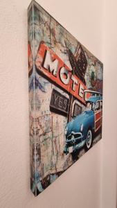 a painting of a car hanging on a wall at Anna Garden Sidari in Sidari