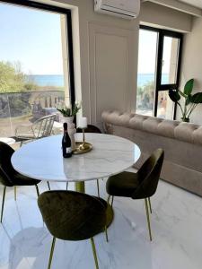 a white table and chairs in a living room at Mali by the Lake - North Mamaia in Mamaia