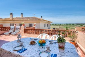 uma mesa azul com pratos de comida num pátio em Lunice em Bellcaire dʼEmpordà