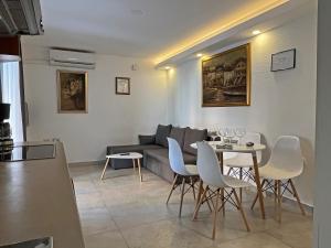a living room with a couch and a table and chairs at Apartments Center Opatija Ziric in Opatija