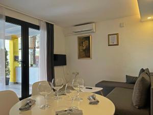 a living room with wine glasses on a table at Apartments Center Opatija Ziric in Opatija