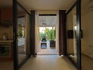 a kitchen with a glass door leading to a patio at Apartments Center Opatija Ziric in Opatija