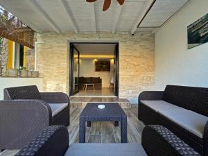 a living room with couches and a table at Apartments Center Opatija Ziric in Opatija