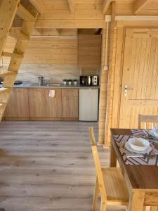 a large kitchen with a table and a counter at Osada Gardenia in Ślesin
