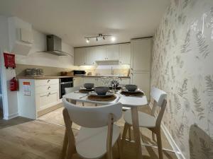 a kitchen with a table and chairs in a room at Wookey Hole Hideaway in Wookey Hole