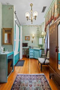 a kitchen with blue cabinets and a chair and a rug at The Peerless Hotel in Ashland