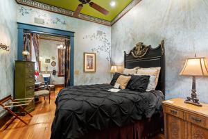 a bedroom with a bed with a black headboard at The Peerless Hotel in Ashland