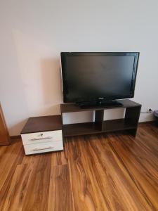 a flat screen tv sitting on top of a wooden floor at Sweet Home & Sweet Cats & Fast internet in Wrocław