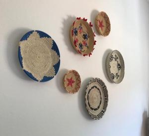 a group of decorative plates on a wall at La Corbula - Casa Vacanze - Q5992 in Fluminimaggiore