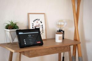 a table with a tablet on top of it at Porthcurno Barns, The Big Barn - Spacious & cosy cottage, walk to Porthcurno beach, Pedn Vouder & Minack Theatre in Penzance