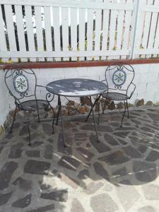a table and two chairs sitting on a patio at Villetta a schiera nei pressi del mare in Livorno