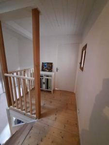 a room with a staircase with a television in it at Logement Sainte-Énimie in Sainte-Énimie