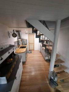 a kitchen with a spiral staircase in a room at Logement Sainte-Énimie in Sainte-Énimie