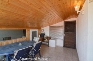 ein Wohnzimmer mit einer Holzdecke und einem Tisch in der Unterkunft Mihaela 2 in Kruševo