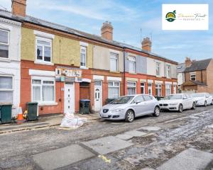 a row of cars parked in front of buildings at LOWest rate 6 Bedroom House 6 Bath in Coventry - City Centre with garden and FREE wi-fi- RRC in Coventry