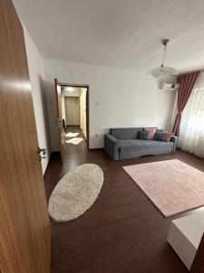 a living room with a couch and two rugs at Class Apartments in Oradea