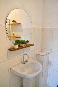 a bathroom with a sink and a mirror at Villa Manga Rosa in Lençóis