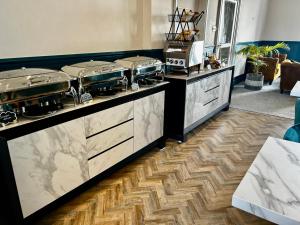 a kitchen with two stoves on a counter at Hotel No5, Beachfront with Free Private Car Park in Llandudno