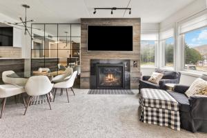 a living room with a fireplace and a tv at 2 BR Ski In Out at Cachet Crossing, Sleeps 8 in Blue Mountains