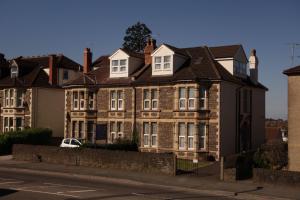 a large brick building on a city street at Filton Guest House in Bristol