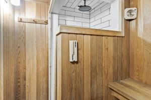 a bathroom with a wooden door in a room at 2 BR Ski In Out at Cachet Crossing, Sleeps 8 in Blue Mountains +34 photos