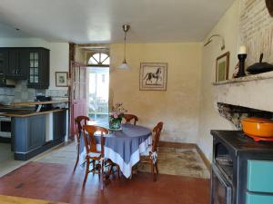 a kitchen with a table and chairs in a room at Gîte à la ferme entre Loire, Vignobles et Bertranges in Vielmanay