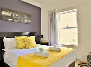 a bedroom with a bed with two towels on it at 721 @ Leisure Bay in Pretoria