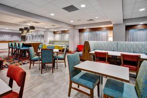 a dining room with tables and chairs and a cafeteria at Hampton Inn Paris, Tn in Paris