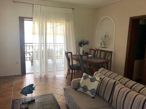a living room with a couch and a table at La Grande Maison,Lefokastro in Afissos