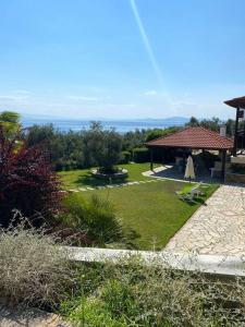 a garden with a gazebo and a lawn sidx sidx sidx at La Grande Maison,Lefokastro in Afissos