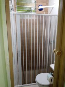 a bathroom with a shower with a toilet at Pousada Reis Guarujá in Guarujá +61 photos