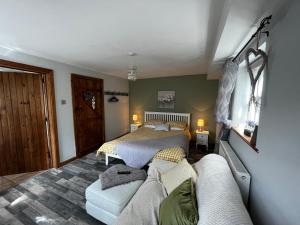 a living room with two beds and a couch at Pear Tree Cottage in Shrewsbury