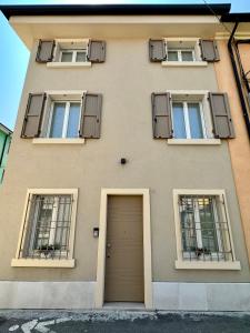 a building with two windows and a door at L’Oleandro in Valeggio sul Mincio +13 photos